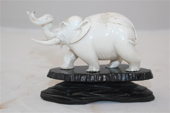 Ivory elephant on stand, a pair of bookends and two ivory bead necklaces